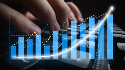Close-up of hands typing on a keyboard while bar graphs and trendlines overlay the image, reflecting growth, analysis, and technology in a business context. Copula