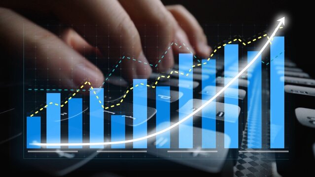 Close-up of hands typing on a keyboard while bar graphs and trendlines overlay the image, reflecting growth, analysis, and technology in a business context. Copula - Powered by Adobe