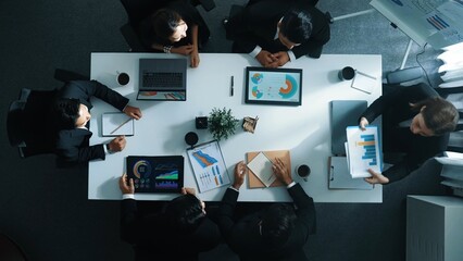Top down aerial view of diverse business team listening manager present growth sales while giving a high five to encourage or motivate team. Group of people celebrate successful project. Directorate.