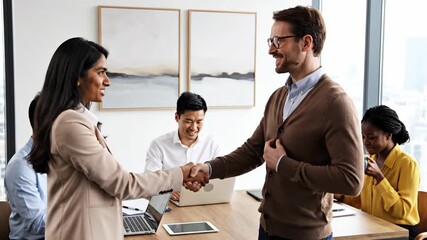 Professionals shaking hands during a diverse business meeting in an office setting
