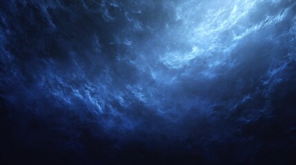 Fototapeta premium A mesmerizing deep blue ocean surface with dramatic lighting and texture.