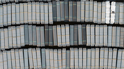 Top down view of several stacks of underground PVC pipe lines at construction site.