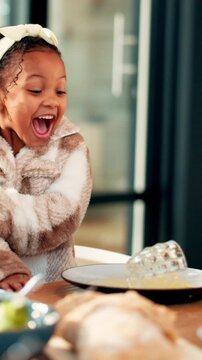 Accident, mess and orange juice with reaction of girl child in home dining room for oops. Glass, mistake and spill with clumsy kid at table in apartment for dinner time, family meal or thanksgiving
