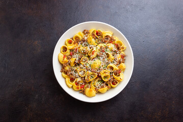 Pasta with bolognese sauce and cheese. Italian cuisine. Traditional recipe.