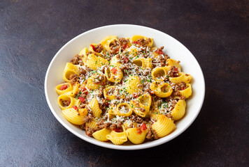Pasta with bolognese sauce and cheese. Italian cuisine. Traditional recipe.