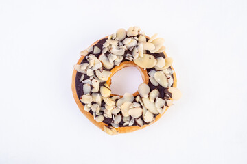 Chocolate garnish Donut. Frosted Chocolate Donut, Chocolate Drizzled Donut, Chocolates donut close-up on a white background.
