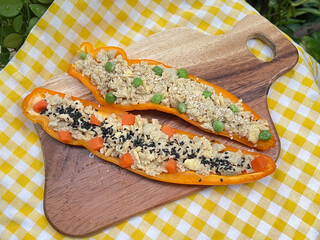 Steamed egg in large Mexican bell pepper with carrot and green peas.