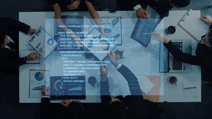 A diverse business team collaborates in an office setting, analyzing data visualizations on digital devices, engaged in strategic discussions and planning. Trope