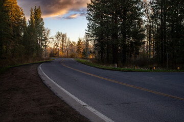 Fototapeta premium A winding country road at sunrise.