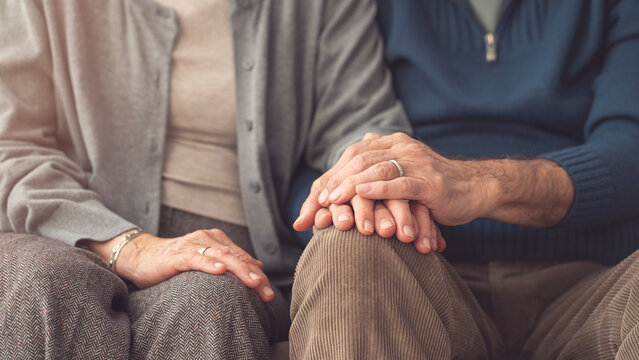 Elderly couple holding hands and supporting each other