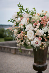 Elegant Outdoor Floral Arrangement in Bronze Urn