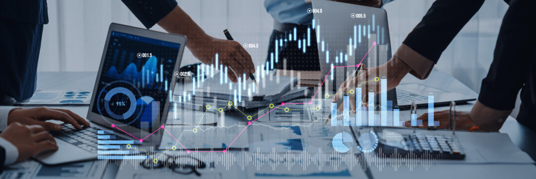 Business professionals collaborate on financial data analysis, using multiple laptops and digital graphics, highlighting modern workspace technology and teamwork. Scalp - Powered by Adobe