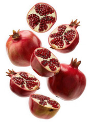 Fresh pomegranates and halves scattered isolated on black background isolated on transparent background