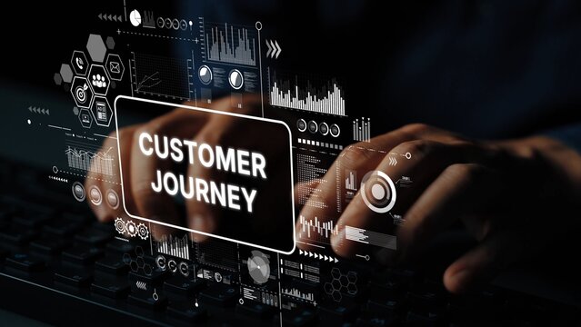 Hands Typing on Keyboard with Customer Journey Interface and Data Visualizations in Background. Asymptotic smart data analytic. - Powered by Adobe