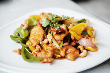 Stired-fried Chicken with Cashew Nuts in white dish. Thai food
