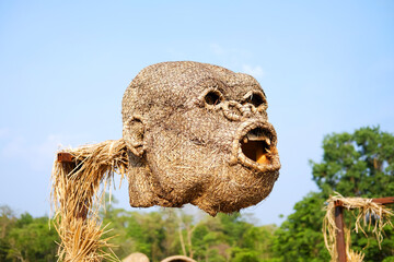 The head of monkey puppet is made from woven straw into the shape of a large gorilla on blue sky in Thailand