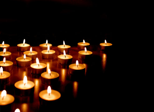 Burning candles on black background