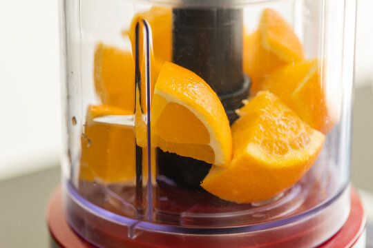 orange pieces in blender close-up