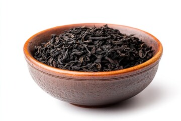 A close-up view of a bowl filled with black tea leaves, set against a white background.