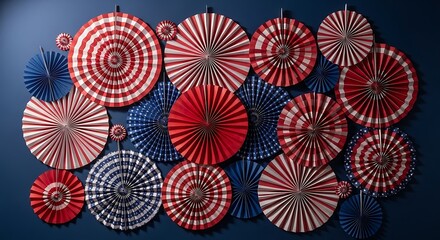 Patriotic red white and blue paper fans and rosettes on dark background