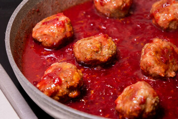 turkey meatballs cooking in cranberry sauce traditional thanksgiving