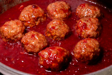 turkey meatballs cooking in cranberry sauce traditional thanksgiving