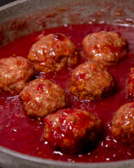 turkey meatballs cooking in cranberry sauce traditional thanksgiving