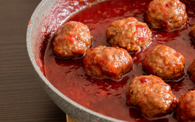 turkey meatballs with cranberry sauce in pan