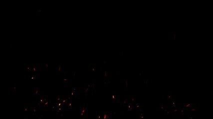 Fiery sparks rising slowly on dark background in cinematic motion