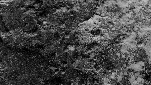 Dark rough rock texture with natural stone patterns and gritty surface details for backgrounds
