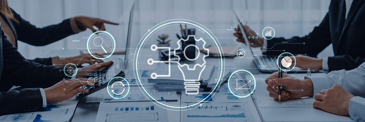 Professionals engage in a collaborative meeting, utilizing technology and data analysis for innovative solutions and project development in a modern office setting. Trope