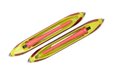 Two brightly colored wooden or ebonite weaving shuttles, essential tools used in handloom and traditional textile production, photographed against a clean white background.