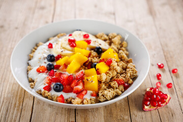 bowl of granola with yogurt and fresh fruits