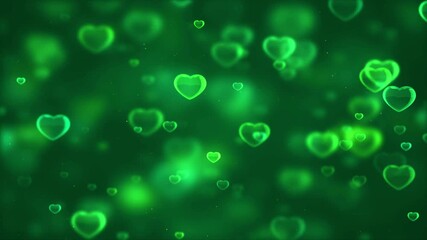 Green heart shaped lights gently float on deep emerald background