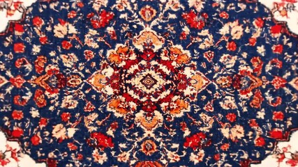 Close-up of ornate floral pattern rug with a central medallion and detailed edge designs - Powered by Adobe