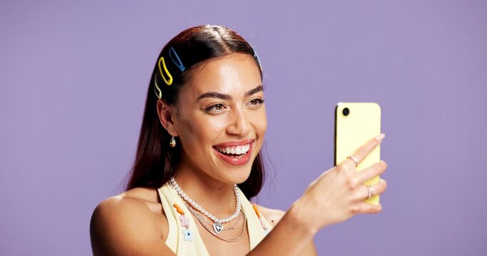 Beauty, selfie and smile with influencer woman in studio for product review on social media. App, haircare and happy with gen z content creator isolated on purple background for post or update - Powered by Adobe