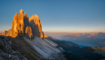 Majestic mountain peaks at sunrise with clear sky background.
