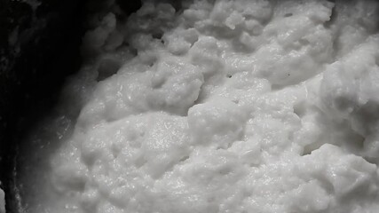 Homemade butter cream is churned malai (milk fat) with water, separating the white butter lumps from residual buttermilk or whey (taak). The washed butter is used fresh or for ghee,  taak is for dahi.