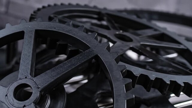 Close-up of metallic gears, in a gray-scale composition, partially blurred to create depth of field