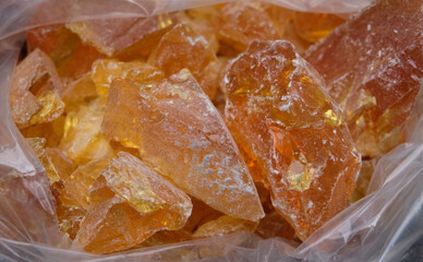Close up of a piece of natural amber in a plastic bag.