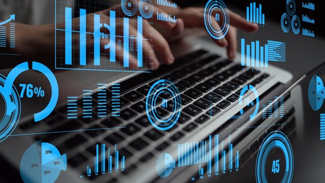 A creative representation of data analysis in a modern workspace, featuring hands typing on a laptop with futuristic graphs and charts overlaying the scene. Xenic