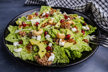 Fresh salad with tuna, avocado, and pomegranate seeds