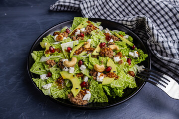 Fresh salad with tuna, avocado, and pomegranate seeds