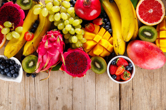 assortment of fresh fruits, top view on wood background
