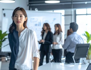 Fototapeta premium Confident Asian Businesswoman Leading a Professional Team Meeting in a Modern Office Environment.