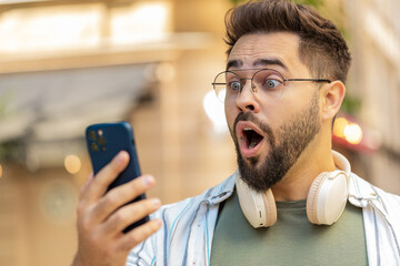 Upset unhappy Caucasian young man guy male using looking mobile smartphone bad connection losing...