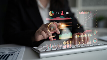 A business professional utilizes a modern keyboard while analyzing data insights displayed through innovative digital graphs and charts in an office setting. Impute