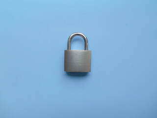 Fototapeta premium Metallic silver padlock isolated on colored background