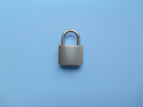 Metallic silver padlock isolated on colored background