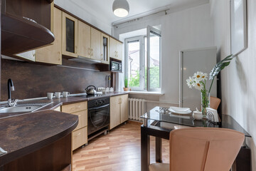 Bright Modern Kitchen Interior with Dining Table and Window